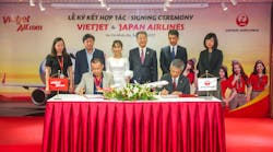 Tadashi Fujita, JAL executive vice president, right front row, and Luu Duc Khanh, Vietjet managing director, left front row, sign the agreement in the witness of Vietjet President CEO Nguyen Thi Ph