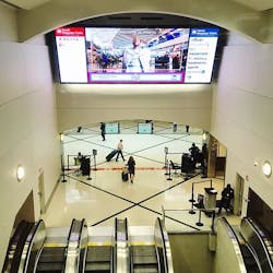 The $2.4 million project involved replacing mirrored walls flanking the escalator with sheetrock walls featuring painted reveals to add architectural detail, as well as replacing the longstanding &ldquo;Spirit of Atlanta&rdquo; mural at the top of the escalator with a giant LED video wall with directional airline signage.
