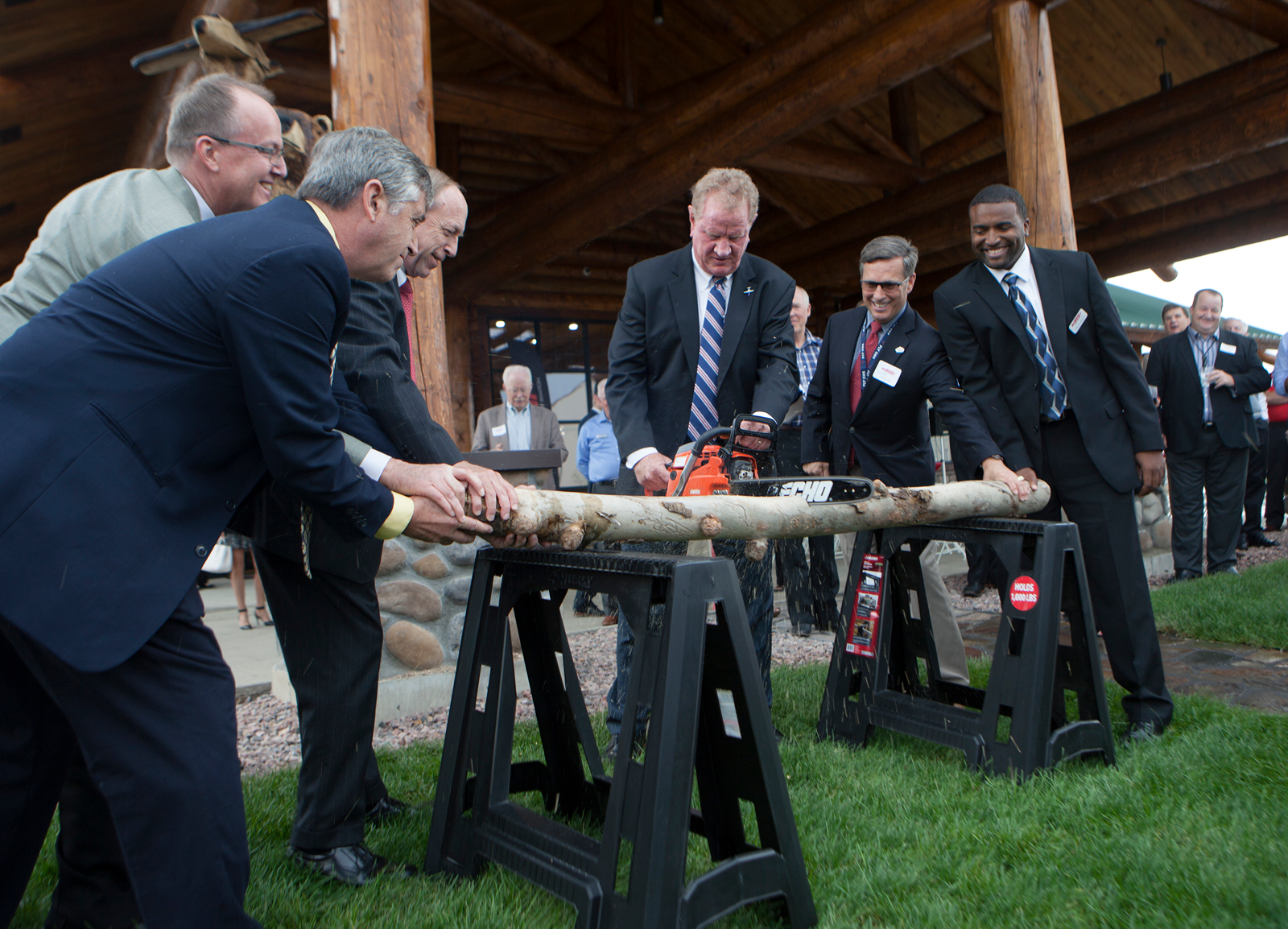 Log cutting ceremony: (left to right) CFO of Cutter Aviation Steve Prieser, Director of Special Projects of Cutter Aviation Mike Livezey, Colorado Springs Mayor John Suthers, CEO of Cutter Aviation Will Cutter, Colorado Springs Director of Aviation Greg Phillips, Cutter Aviation Colorado Springs General Manager Calvin Martin.