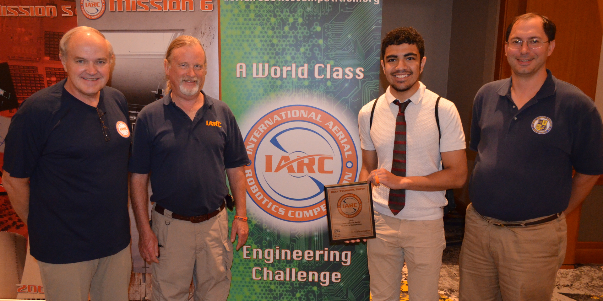 NDSU Computer Science student and team lead Abdullah Almosalami receives the team's award at the International Aerial Robotics Competition.