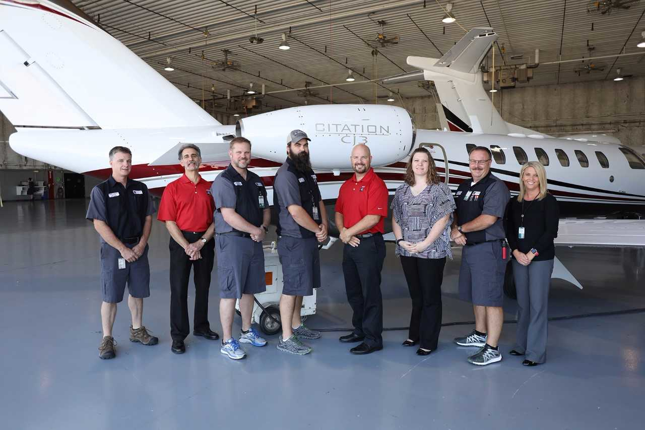 Members of Duncan Aviation's CJ3 team pose with another upgraded aircraft just before it delivers to an excited operator.