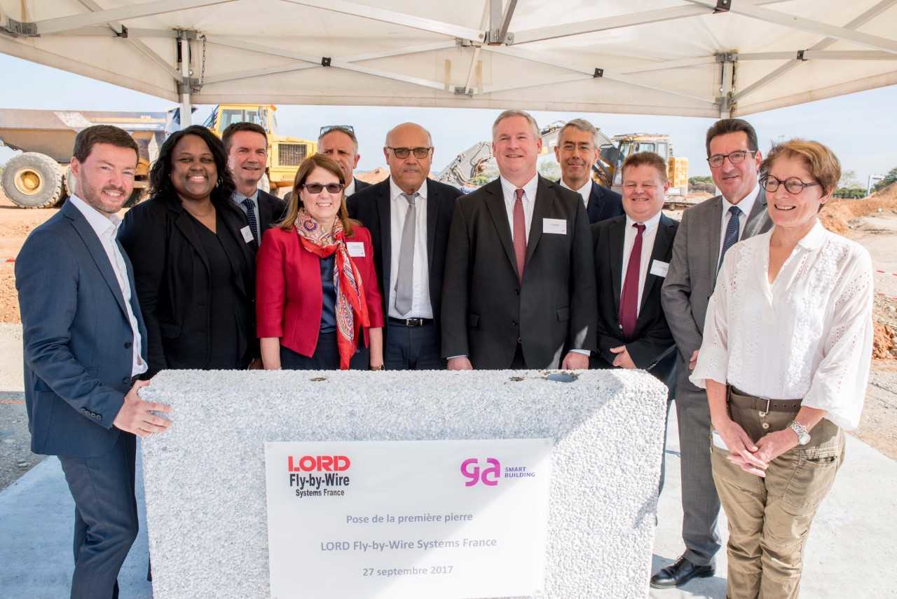 LORD leadership and local officials place the ceremonial 'first stone' for the company's new aerospace center in France.