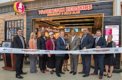 Celebrating the Burgundy & Gold Club opening from left to right: Rod Nenner, Vice President, Washington Redskins; Chryssa Westerlund, Vice President of Marketing and Consumer Strategy, Metropolitan Washington Airports Authority; Clarence LeJeune, Regional Vice President for MarketPlace Development; Stephanie Havard, Executive Vice President of Restaurant Development at HMSHost; Larry Michael, Voice of the Washington Redskins; Mary Morgan, President, Morgan Group Ventures; Jerome L. Davis, Executive Vice President and Chief Revenue Officer, Metropolitan Washington Airports Authority; Steven Baker, Deputy Vice President of Real Estate, Metropolitan Washington Airports Authority; Bryan Loden, Vice President of Business Development at HMSHost; and Kimberly Barnes, Marketing Program Manager, Metropolitan Washington Airports Authority. Celebrating the Burgundy & Gold Club opening from left to right: Rod Nenner, Vice President, Washington Redskins; Chryssa Westerlund, Vice President of Marketing and Consumer Strategy, Metropolitan Washington Airports Authority; Clarence LeJeune, Regional Vice President for MarketPlace Development; Stephanie Havard, Executive Vice President of Restaurant Development at HMSHost; Larry Michael, Voice of the Washington Redskins; Mary Morgan, President, Morgan Group Ventures; Jerome L. Davis, Executive Vice President and Chief Revenue Officer, Metropolitan Washington Airports Authority; Steven Baker, Deputy Vice President of Real Estate, Metropolitan Washington Airports Authority; Bryan Loden, Vice President of Business Development at HMSHost; and Kimberly Barnes, Marketing Program Manager, Metropolitan Washington Airports Authority.
