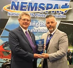 Brad Simmons (L) accepts the NEMSPA Pilot of the Year award from President of NEMSPA, Miles Dunagan.