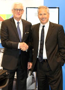 (L-R) Joe Moeggenberg, the CEO of ARGUS International, congratulates Jeff Moneypenny, the Vice President of Sales for Ultimate Jet Charters, at NBAA.