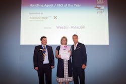 Becky Carver (Managing Director of Weston Aviation) receiving the Award from BACA Chairman Richard Mumford and George Galanopoulos, Managing Director of Luxaviation UK