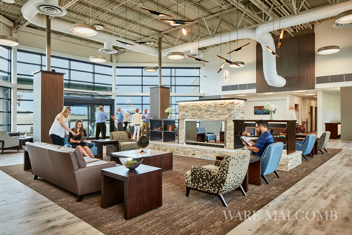 The new terminal design&rsquo;s warm and inviting style represents the Midwestern locale and the interior architecture complements the streamlined design of the surrounding planes with clean lines and geometries.