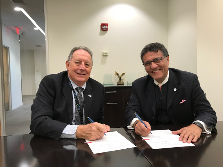 CLE Airport Director Robert Kennedy and Fraport USA President and CEO Ben Zandi sign the contract extension.