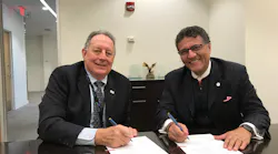 CLE Airport Director Robert Kennedy and Fraport USA President and CEO Ben Zandi sign the contract extension.