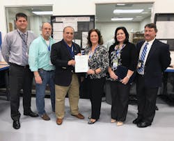 From left, Stanley Routh, FAA Aviation Safety Inspector - Airworthiness; Rob Miller, East/West Industries (EWI) Sr. Quality Engineer; Joseph Spinosa, EWI VP Business Development; Teresa Ferraro, EWI President; Liz Maida, EWI Process Improvements Manager; and Conrad J. DePinto, FAA ASI/PMI - Airworthiness.