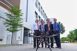M1 Chief Operating Officer Patrick Scodeller, M1 Chief Technical Officer Denis Seek and NTU ATMRI Director Prof Duong and NTU Prof Low Kin Huat with the custom drone built by NTU which can be controlled through M1&rsquo;s 4.5G mobile network.