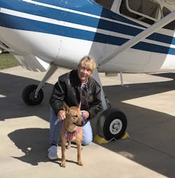 Susan Dusenbury with her dog, Taylor. That's her 1953 Cessna 180 in the background. Susan Dusenbury with her dog, Taylor. That's her 1953 Cessna 180 in the background.
