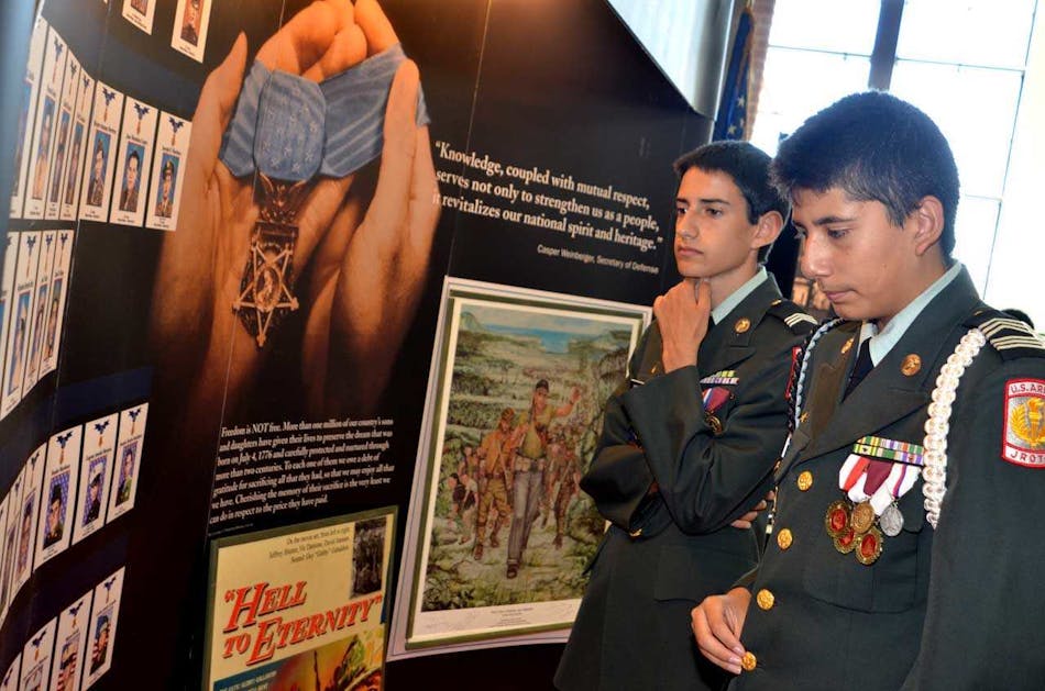 Young JROTC cadets study part of the Hispanic Medal of Honor exhibit that will be on display this year at the 15th annual World War II Heritage Days, April 21-22 at the CAF Dixie Wing Warbird Museum and grounds in Peachtree City, Ga. This year the CAF Dixie Wing is saluting all WWII Medal of Honor recipients.