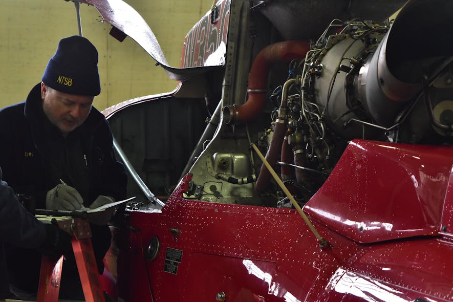 Harald Reichel, an Aerospace Engineer with the NTSB&apos;s Office of Aviation Safety, examines the engine of a Liberty Helicopters&apos; helicopter that crashed in the East River here Sunday, March 11, 2018. The NTSB&apos;s Go Team has formed an operations group, airworthiness group, powerplants group and a survival factors group to conduct the NTSB&apos;s investigation of the crash. Reichel is the chair of the powerplants group. A weather group and air traffic control group were also formed using NTSB investigators in Washington.