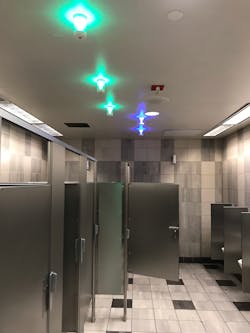 Green lights indicate a stall is empty while blue lights indicate the location of a handicap-accessible stall. Green lights indicate a stall is empty while blue lights indicate the location of a handicap-accessible stall.