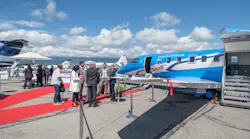 Exhibitors and attendees explore the static display at Geneva International Airport.