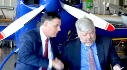 Bridgewater State University (BSU) President Fred Clark (left) happily shakes Cape Cod Community College (CCCC) President John Cox’s hand as President Cox raises the agreement both just signed, giving CCCC students in the Aviation Maintenance Program, access to student housing on the BSU campus.