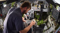 Fargo Jet Center technician Cole Anderson installs a system controller for Skytrac Satcom system retrofit in conjunction with WAAS &amp; ADS-B upgrades in a Lear 45.
