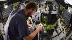 Fargo Jet Center technician Cole Anderson installs a system controller for Skytrac Satcom system retrofit in conjunction with WAAS & ADS-B upgrades in a Lear 45.