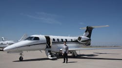 Company President and CEO John Owen stands in front of an Executive AirShare Embraer Phenom 300 at Centennial Airport.