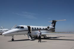 Company President and CEO John Owen stands in front of an Executive AirShare Embraer Phenom 300 at Centennial Airport.