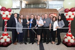 Holding and cutting the ribbon to celebrate new Briggo Coffee Haus at Austin-Bergstrom International Airport are from left: Charles Studor, Briggo Founder/CTO; Kevin Nator, Briggo President/CEO and co-founder; Susana Carbajal, Assistant Director, Austin-Bergstrom International Airport; and Terry Mahlum, GM of Delaware North