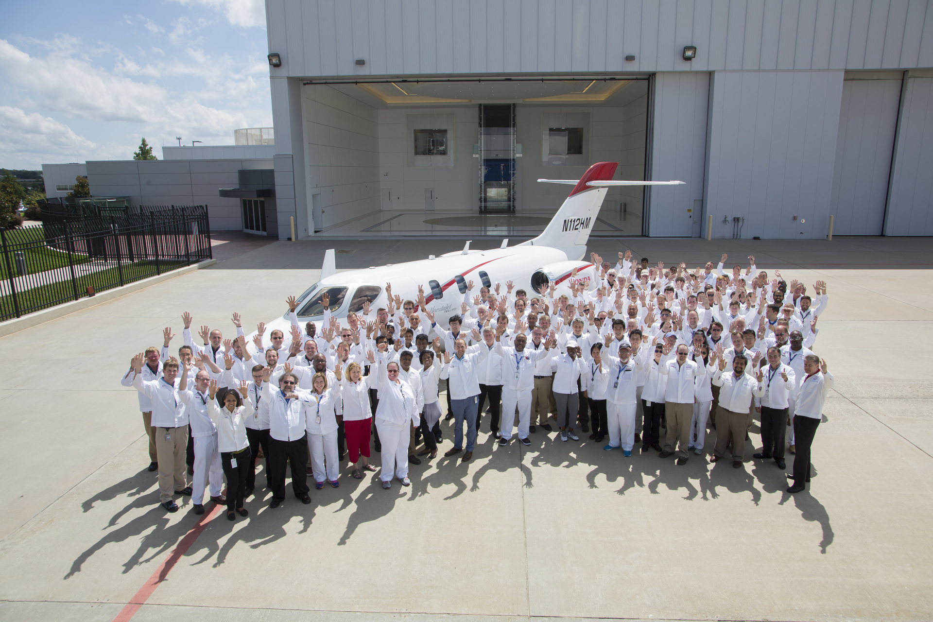 Honda Aircraft Company associates celebrate the delivery of the first HondaJet Elite.