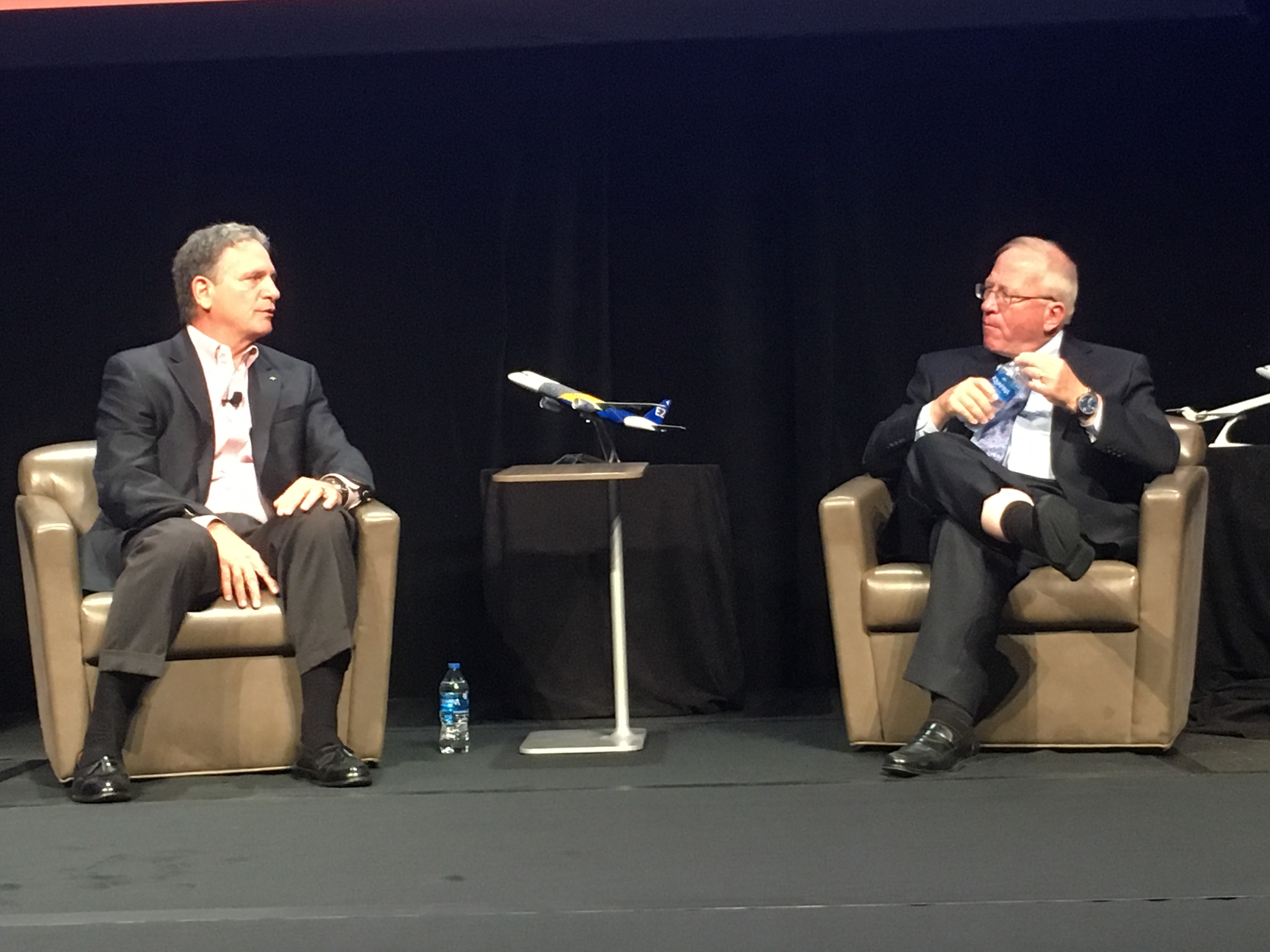 Spirit Airlines CEO Bob Fornaro, left, talks with Boyd Group International President Michael Boyd about the state of his airline and the impact it's having on commercial airport traffic.