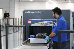 A TSA officer places a passenger's tray into the computed tomography (CT) scanner being tested in Terminal 1 at Los Angeles International Airport. A TSA officer places a passenger's tray into the computed tomography (CT) scanner being tested in Terminal 1 at Los Angeles International Airport.