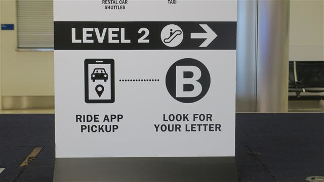 An example of the new Ride App Pickup icon in Terminal 2's baggage claim area, with instructions on how to find the nearest ride app pickup area.