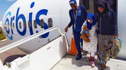 Orbis staff nurse Gloria Rhomes assisted Rahmet, age 9, from the Flying Eye Hospital after her cataract surgery in Addis Ababa, Ethiopia.