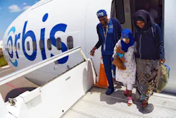 Orbis staff nurse Gloria Rhomes assisted Rahmet, age 9, from the Flying Eye Hospital after her cataract surgery in Addis Ababa, Ethiopia. Orbis staff nurse Gloria Rhomes assisted Rahmet, age 9, from the Flying Eye Hospital after her cataract surgery in Addis Ababa, Ethiopia.