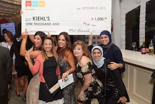 From left to right, Asimena Patsaros, Lisa Mease Ho, Lauren Rago, Leslie Hatton, Fatima Boulhaj and Keltoum Guihia celebrating with the Merchant of the Year check.
