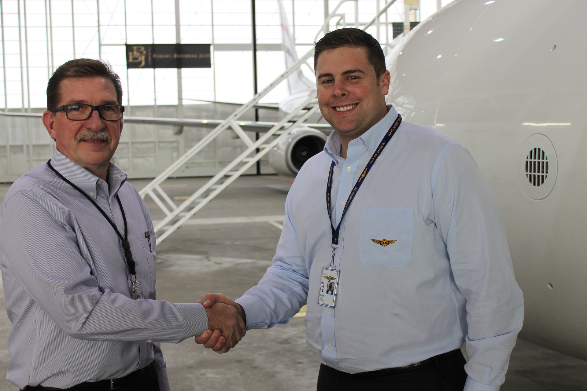 New King Aerospace Commercial Corporation General Manager (left) shakes hands with company President Jarid King.