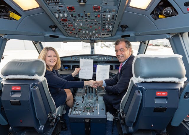 Michele Evans, Lockheed Martin Aeronautics Executive Vice President, and Fernando Alonso, Airbus Defence and Space Head of Military Aircraft, shake hands after signing a Memorandum of Agreement.