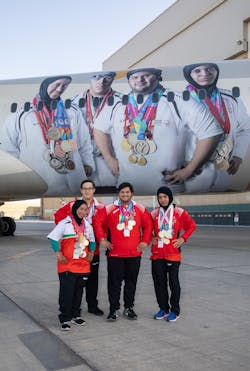 Special Olympics athletes infront of the branded Boeing 787-9. Special Olympics athletes infront of the branded Boeing 787-9.