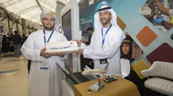 (From left): A young innovator at Think Science Fair, with Abdul Rahman Ahmad Alawi, IT Project Officer, Etihad Airways, at Etihad Aviation Group's stand.