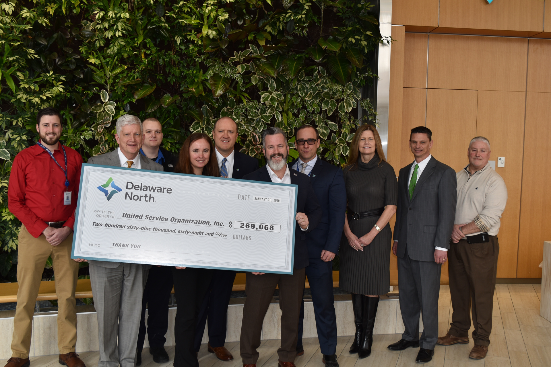 Representatives from the USO joined Kevin Kelly (second from left), president of Delaware North&rsquo;s travel division, Maureen Sweeny (third from right), executive vice president and chief development officer for Delaware North, and several Delaware North associates who have served in the armed forces, for a check presentation ceremony on February 18 at Delaware North&rsquo;s global headquarters in Buffalo, N.Y.