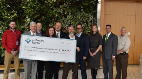 Representatives from the USO joined Kevin Kelly (second from left), president of Delaware North&rsquo;s travel division, Maureen Sweeny (third from right), executive vice president and chief development officer for Delaware North, and several Delaware North associates who have served in the armed forces, for a check presentation ceremony on February 18 at Delaware North&rsquo;s global headquarters in Buffalo, N.Y.