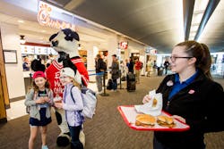 Chick-fil-A’s famous cow kicks off Clinton National Airport opening, encouraging guests to 'EAT MOR CHIKIN' with signature chicken sandwich samples. ) Chick-fil-A’s famous cow kicks off Clinton National Airport opening, encouraging guests to 'EAT MOR CHIKIN' with signature chicken sandwich samples. )