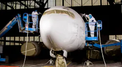 Technicians at Sherwin-Williams give a plane a white coat of paint.