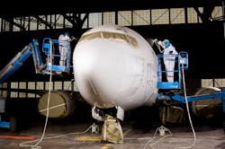 Technicians at Sherwin-Williams give a plane a white coat of paint. Technicians at Sherwin-Williams give a plane a white coat of paint.