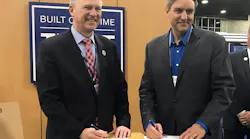 David Davenport, Co-CEO and President, Commercial of FlightSafety International, and Leo Morrissette, Executive Vice President of Air Methods signing the agreement.