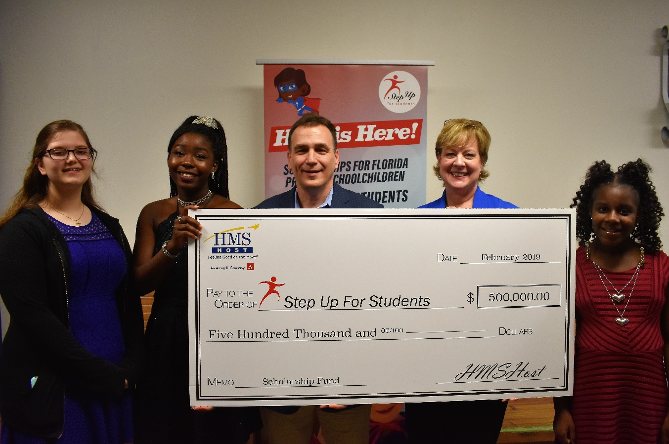 HMSHost celebrated with Step Up For Students again on February 28, 2019 at Impact Christian Academy in Jacksonville, Florida. Pictured (adults from left to right) are HMSHost Vice President of Business Development Stephen Douglas and Step Up For Students COO Anne White. They are joined by students who are benefiting from the scholarship.