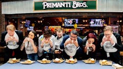 VIP guests take the first bite of Primanti Bros. celebrated sandwich at its new restaurant and bar at Pittsburgh International Airport. Shown are Allegheny County Executive Rich Fitzgerald; Allegheny County Airport Authority CEO Christina Cassotis; Fraport USA President and CEO Ben Zandi; Primanti Bros. President and CEO David Head; and the Primanti Bros. team.