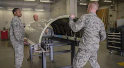 U.S. Air Force sheet metal technicians with the 116th and 461st Air Control Wing(s) aircraft structural maintenance sections secure a cowling on the newly-created cowling fixture table April 3, 2019, at Robins AFB, Ga. Eight Airmen from Team JSTARS recently designed an innovative tool estimated to save the Air Force nearly $500k a year in cowling repairs for the aircraft.