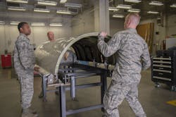U.S. Air Force sheet metal technicians with the 116th and 461st Air Control Wing(s) aircraft structural maintenance sections secure a cowling on the newly-created cowling fixture table April 3, 2019, at Robins AFB, Ga. Eight Airmen from Team JSTARS recently designed an innovative tool estimated to save the Air Force nearly $500k a year in cowling repairs for the aircraft. U.S. Air Force sheet metal technicians with the 116th and 461st Air Control Wing(s) aircraft structural maintenance sections secure a cowling on the newly-created cowling fixture table April 3, 2019, at Robins AFB, Ga. Eight Airmen from Team JSTARS recently designed an innovative tool estimated to save the Air Force nearly $500k a year in cowling repairs for the aircraft.
