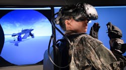 In her virtual reality (VR) headset, an aircraft maintainer is able to interact with a virtual platform including familiarization exercises on how to repair/replace parts or perform troubleshooting. She also has the capability to interact with other maintenance personnel or instructors across multiple locations, making it easier to train and gain proficiency.
