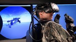 In her virtual reality (VR) headset, an aircraft maintainer is able to interact with a virtual platform including familiarization exercises on how to repair/replace parts or perform troubleshooting. She also has the capability to interact with other maintenance personnel or instructors across multiple locations, making it easier to train and gain proficiency. In her virtual reality (VR) headset, an aircraft maintainer is able to interact with a virtual platform including familiarization exercises on how to repair/replace parts or perform troubleshooting. She also has the capability to interact with other maintenance personnel or instructors across multiple locations, making it easier to train and gain proficiency.