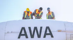 Africa World Airways technicians finishing a maintenance task on left engine.
